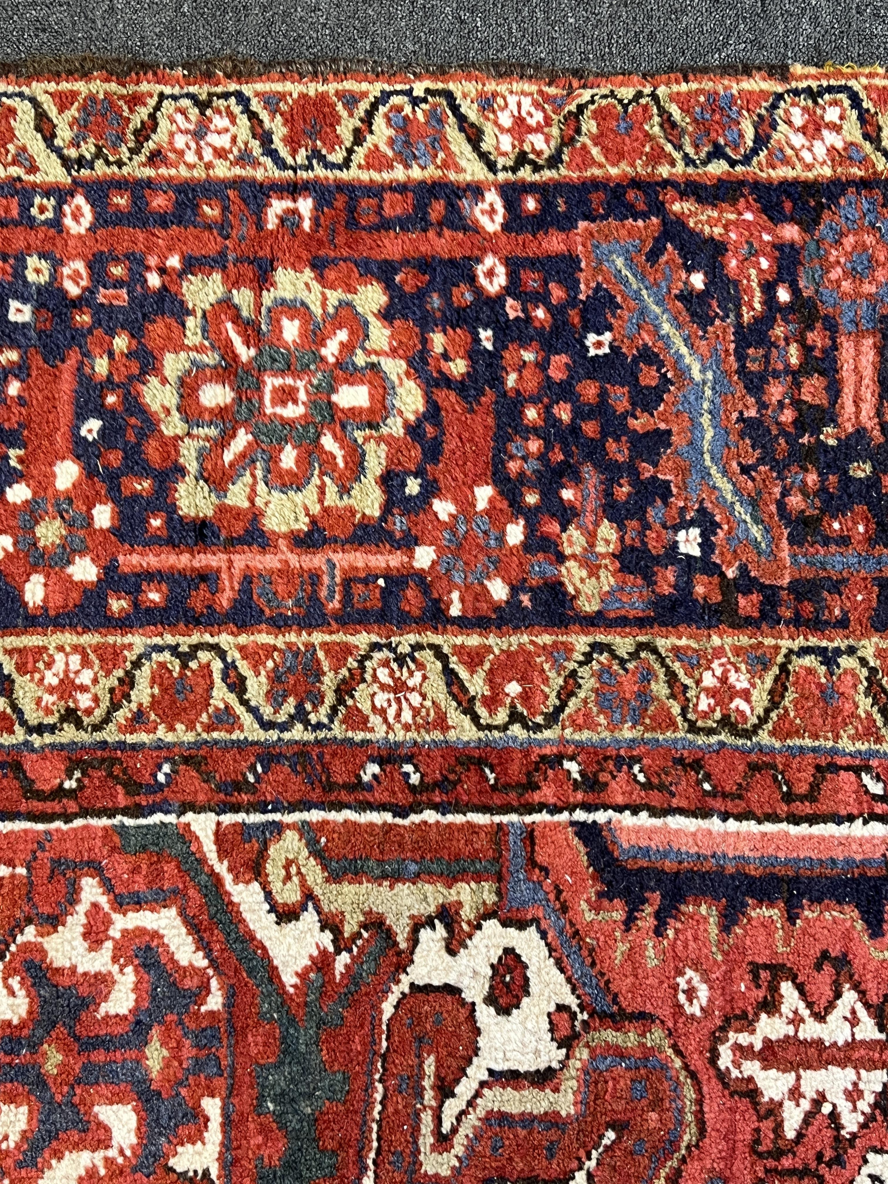 An antique Heriz carpet, 410 x 295cm